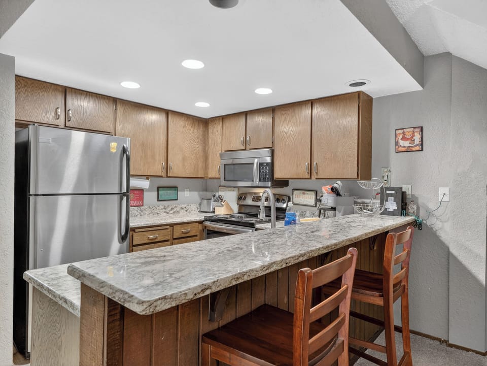 Cook your favorite meals in this fully equipped kitchen with granite countertops, stainless appliances, and breakfast bar seating.