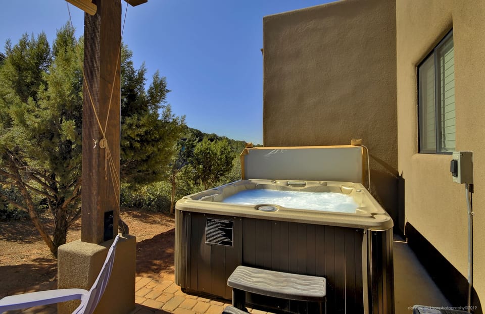 back patio  has a hot tub w/views of the Airport Trail.
