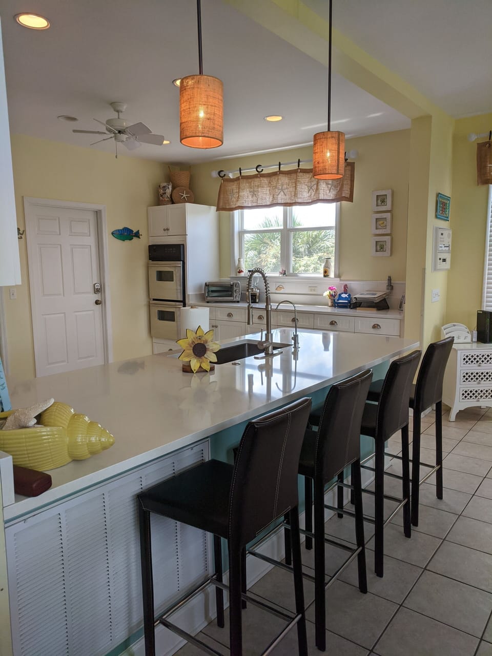 Sunshine & counter space for sous chefs! SS double ovens & extra seating too!