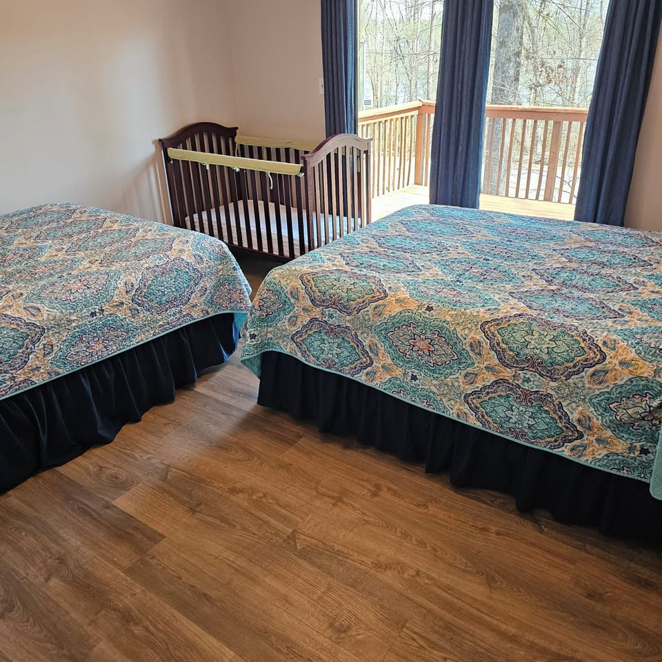 Double bedroom with two queen beds and crib