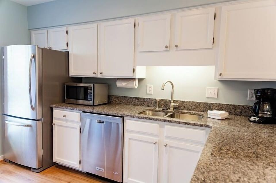 - Bright and welcoming kitchen with sleek granite countertops and full amenities - Stainless steel dishwasher and deep sink make cleanup a breeze after meals - Perfect space for prepping snacks, pouring wine, or whipping up breakfast