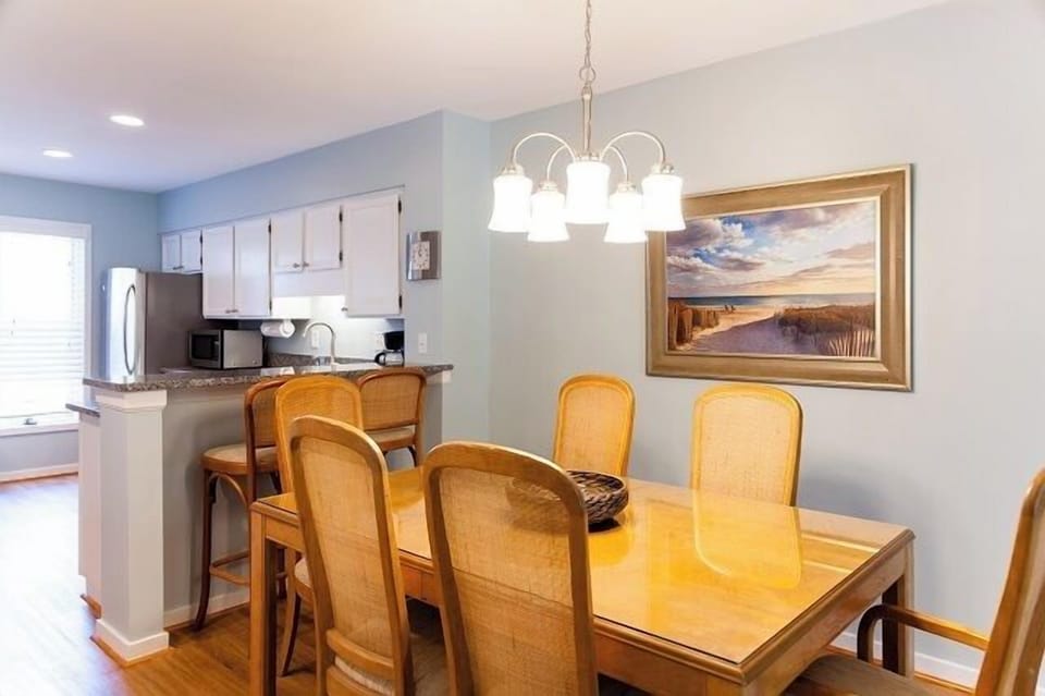 - Bright dining space with seating for six, perfect for morning coffee or evening dinners - Large wall art and soft wall tones create a serene and welcoming atmosphere - Barstool seating at the counter offers a casual spot to snack or chat with the chef