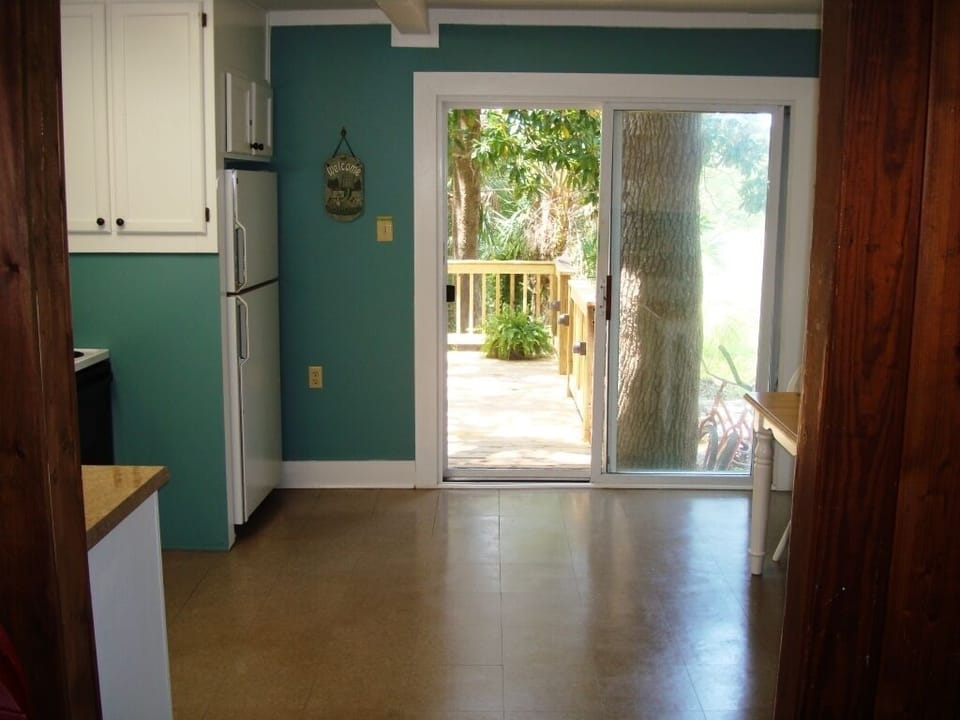 View from greatroom through kitchen to back deck