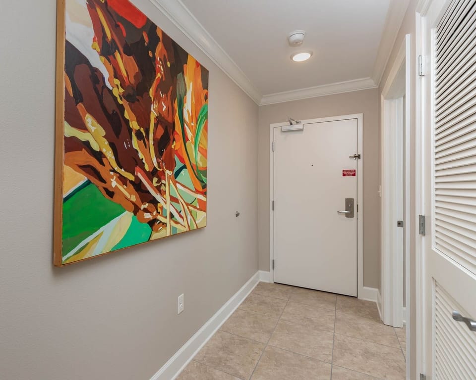 Step inside to a welcoming entryway adorned with lively artwork, inviting you to begin your coastal retreat