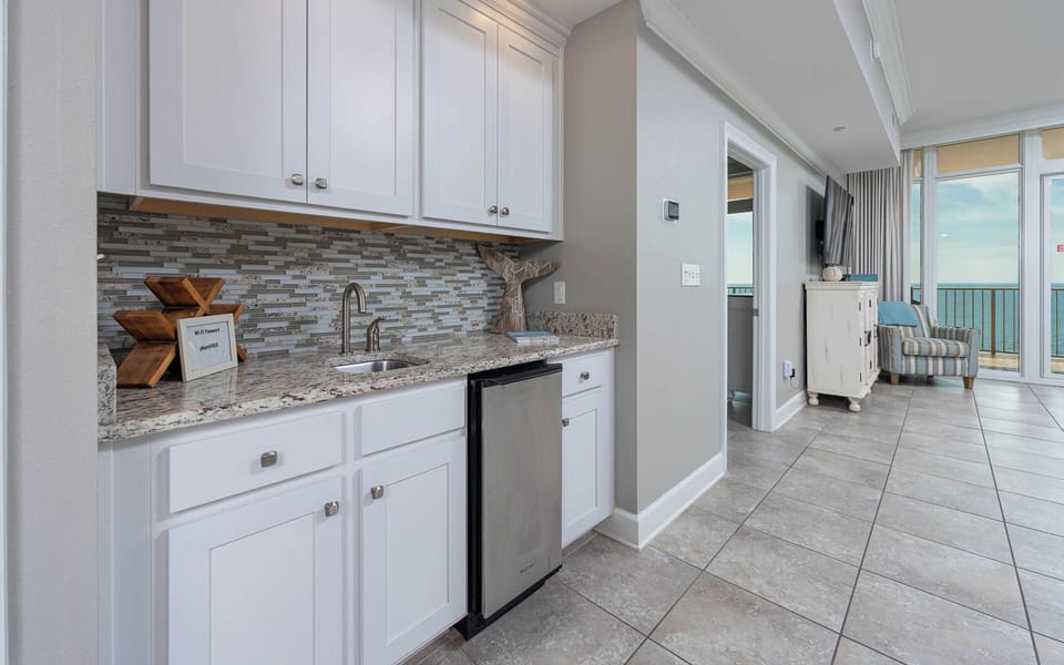 Grab a chilled drink from the fridge or create your favorite cocktail at the wet bar with elegant glassware displays