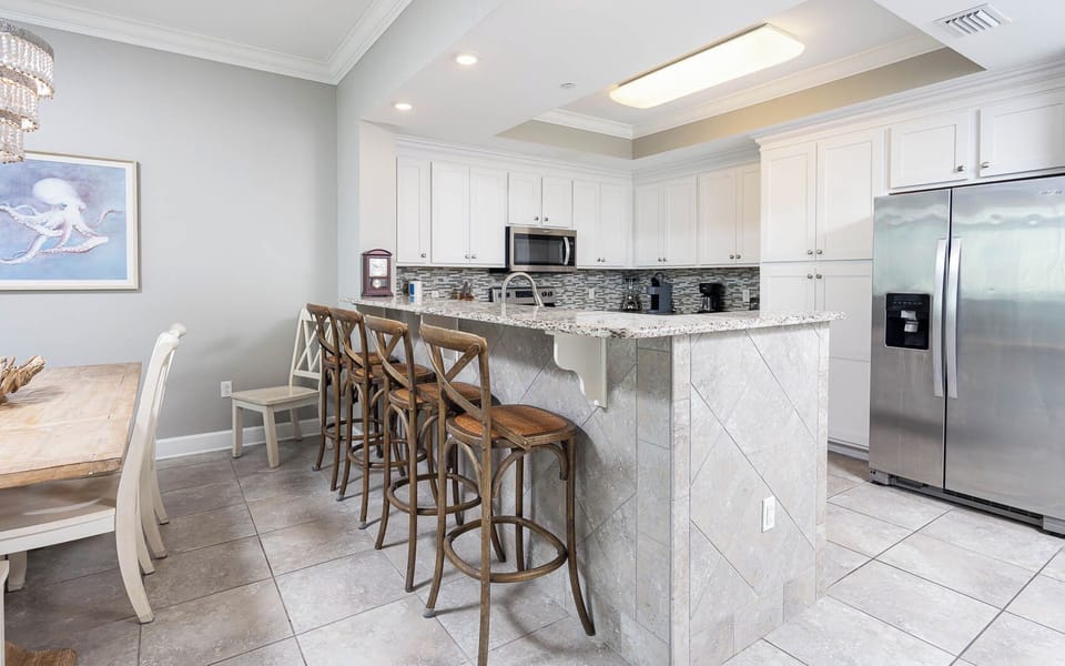 Sip your morning coffee at the breakfast bar and get ready for a beach day in this stylish space
