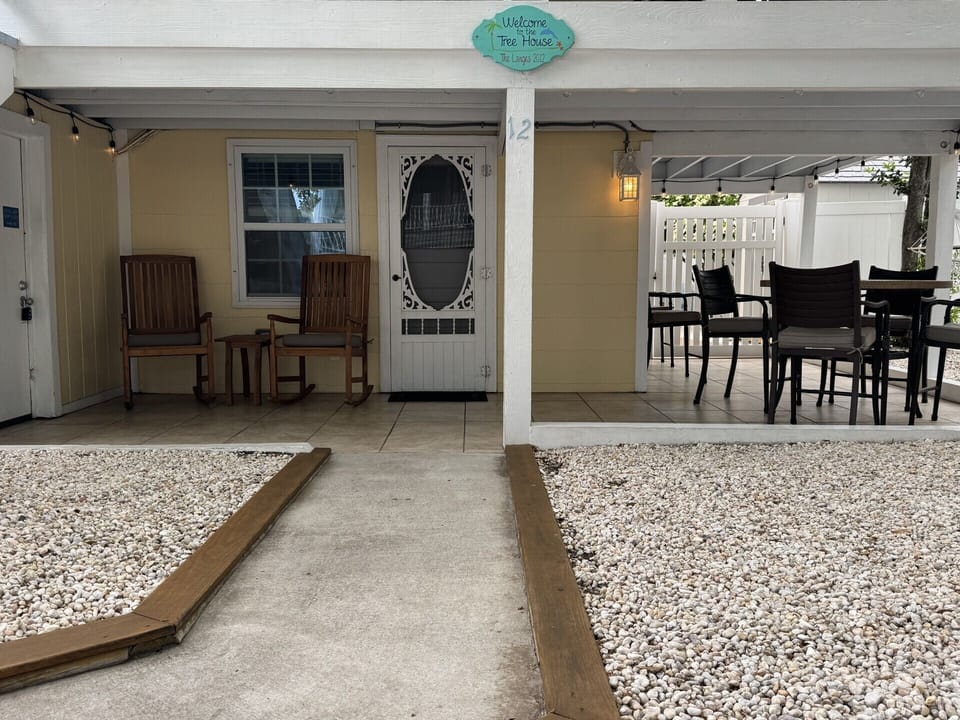 Ground Level covered patio with table for 4 and 2 rocking chairs!