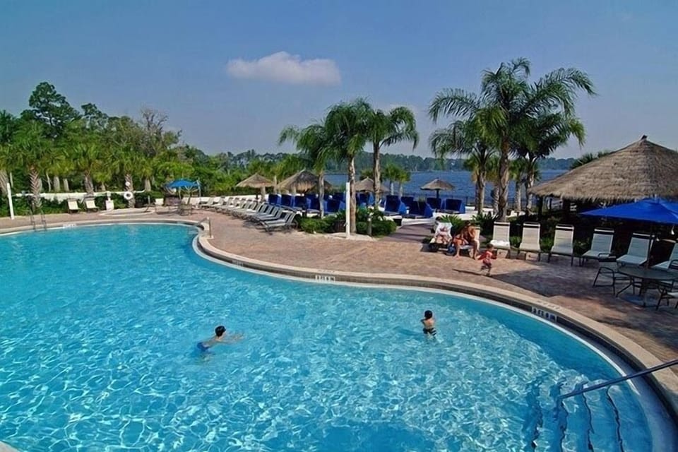 Heated pool with beach and lake beyond (2 mins from our condo)