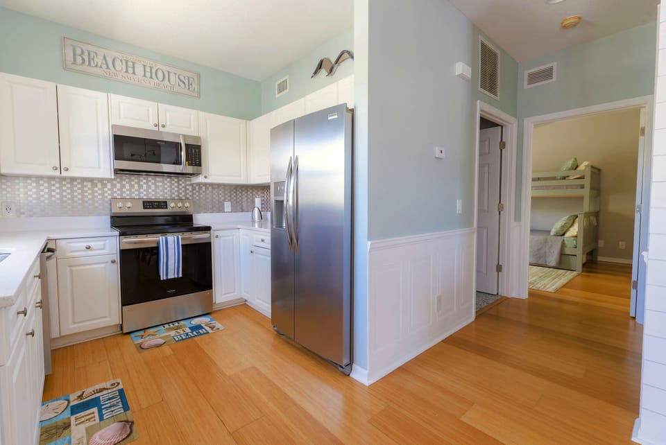 Hallway leading to laundry room, bathroom and second bedroom.
