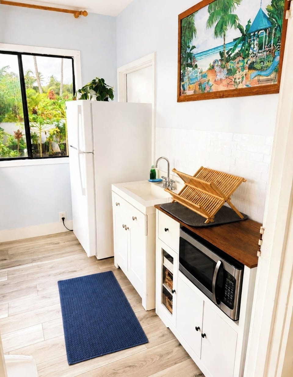 The kitchenette featuring a full sized refrigerator, a microwave, and sink!