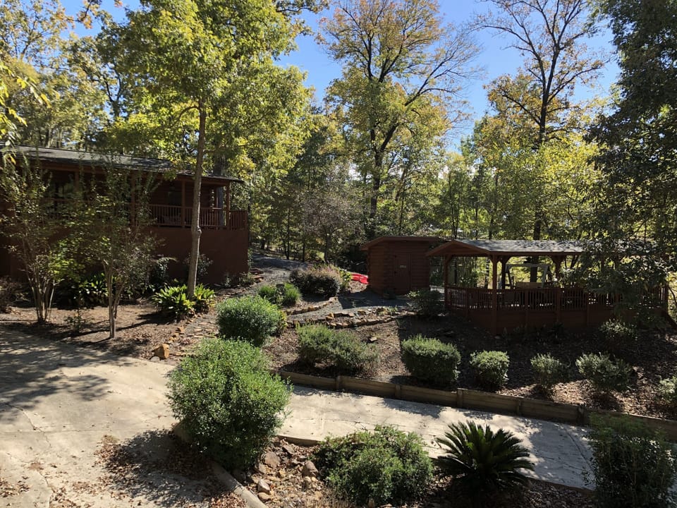 Boat ramp, house and pavilion on beautiful grounds.
