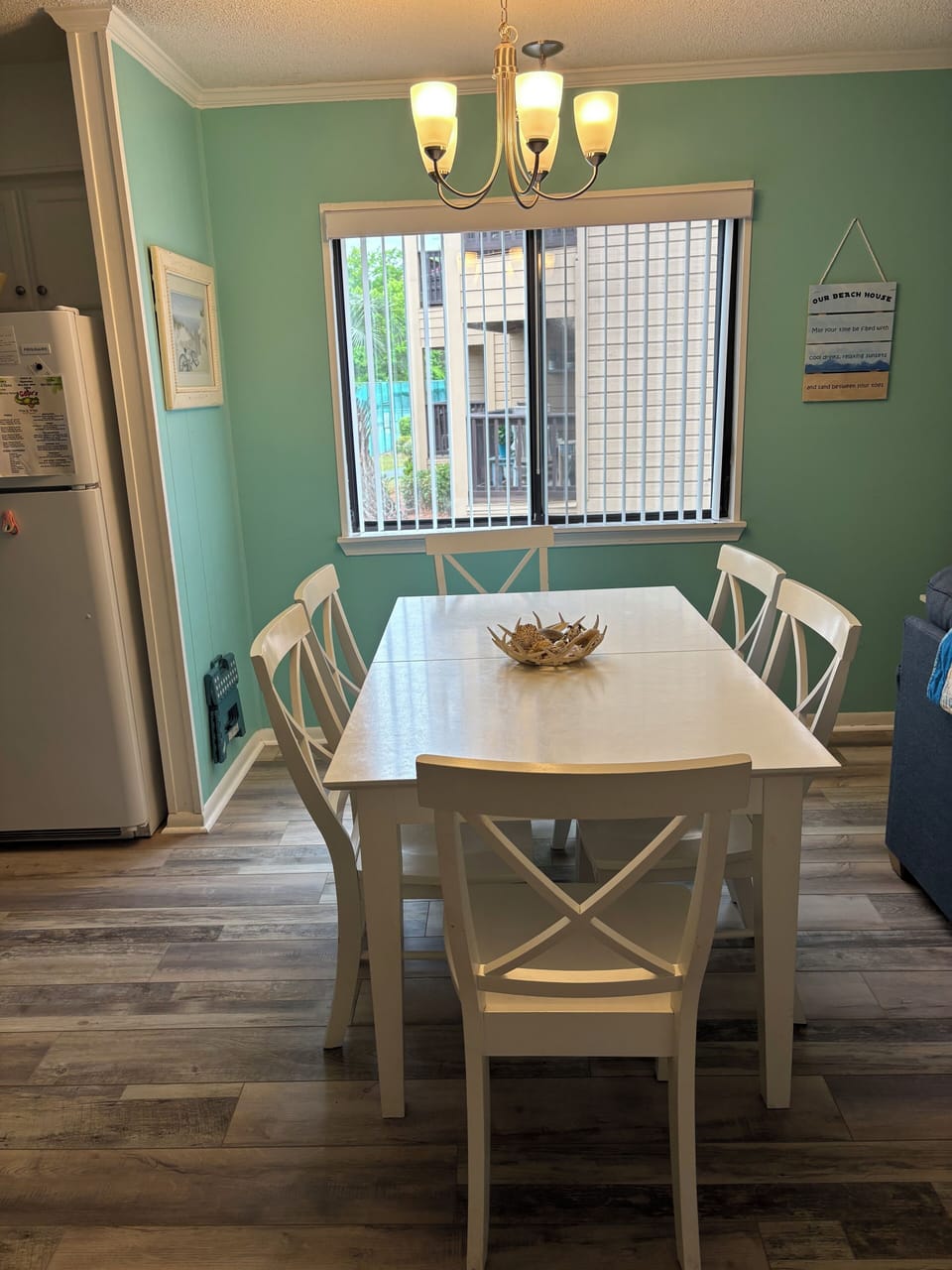 Bright dining area  with new windows, comfortably seats six.