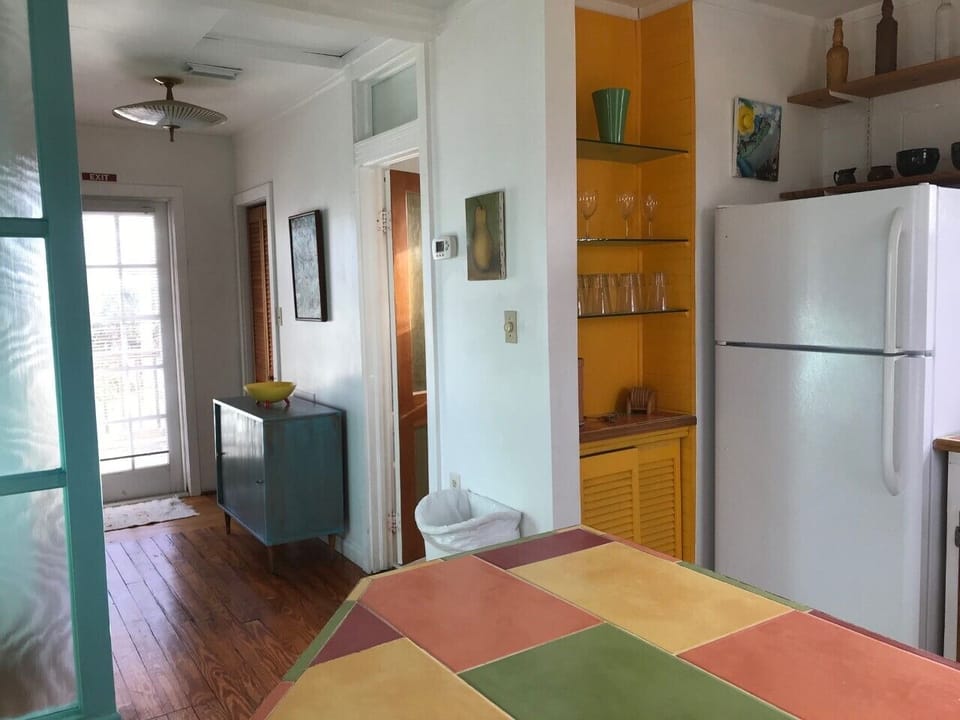 Hallway to the deck with bathroom door on the right. 