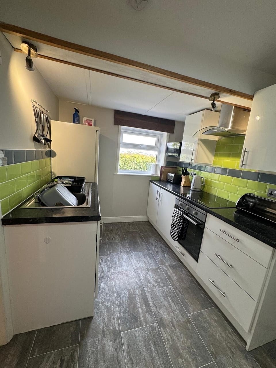 kitchen with oven, ceramic hob, microwave, large fridge freezer, dishwasher