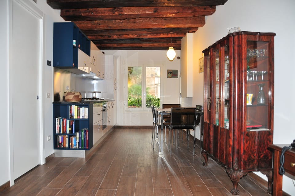 Living-room with furniture, kitchen and window on the garden
