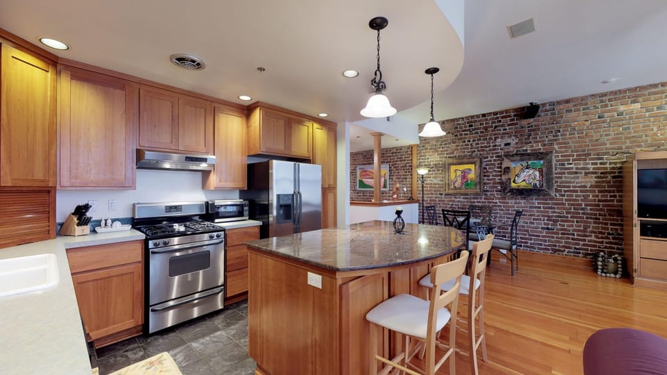 love the brick and original birch wood floors.
