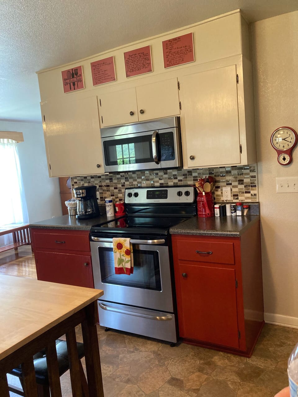 Complete kitchen with range, microwave and coffee pot with coffee provided.
