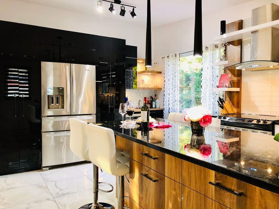 Modern kitchen with large refrigerator, filtered water, and ice dispenser.