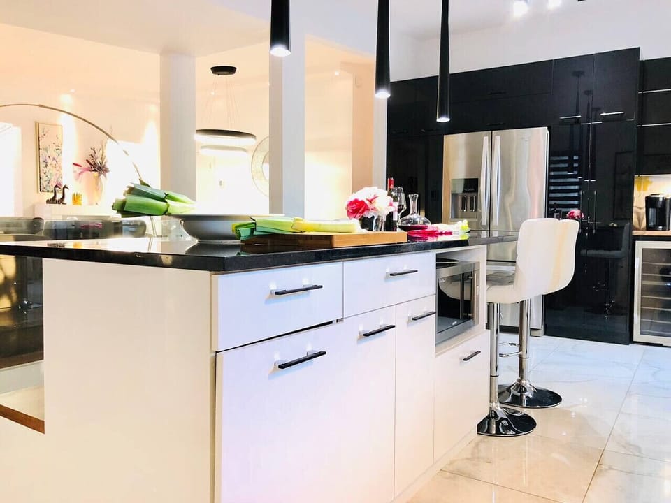 Modern kitchen with central island, designed to cook comfortably like at home.