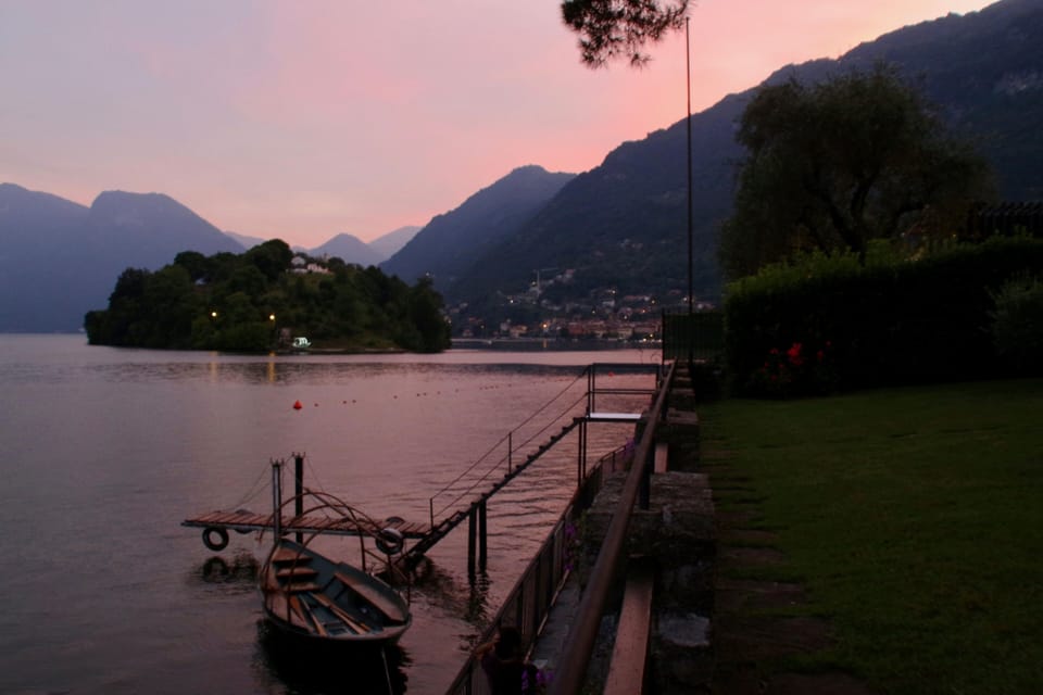 The view of the dock, island and lake at sunset.