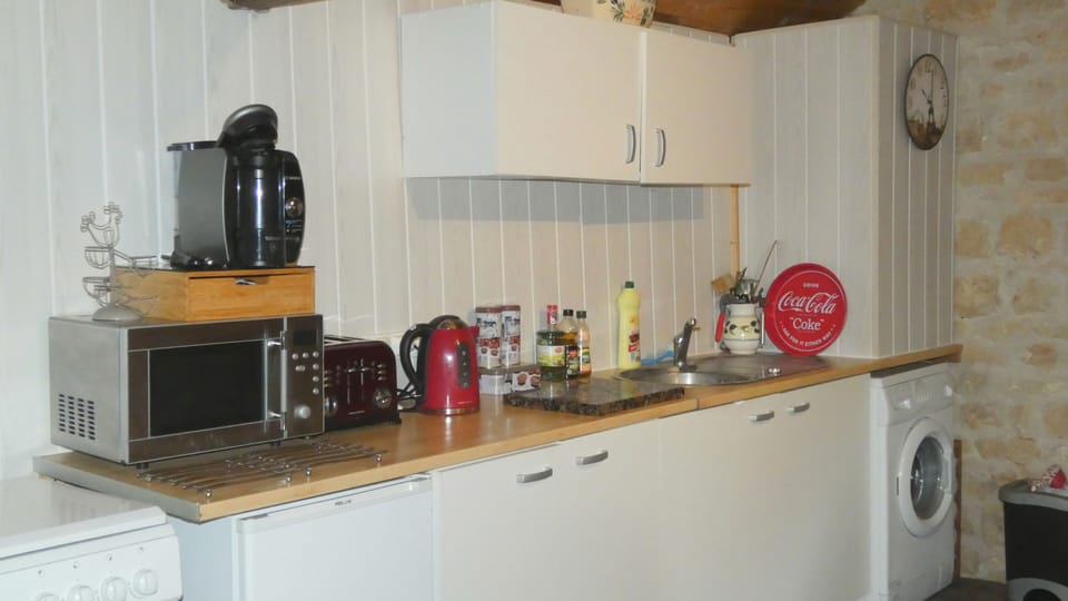 Well provisioned kitchen with washing machine.