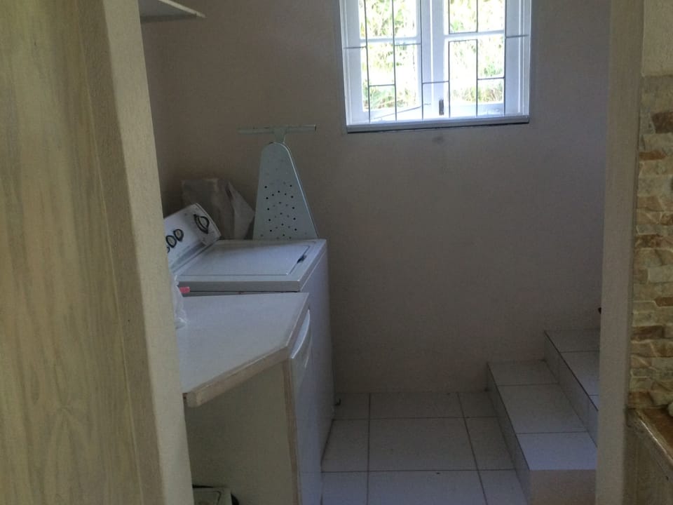 utility room showing dishwasher, washing machine, ironing etc