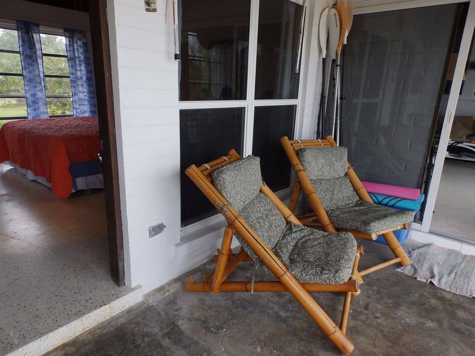 Master bedroom with back porch seating perfect for morning coffee