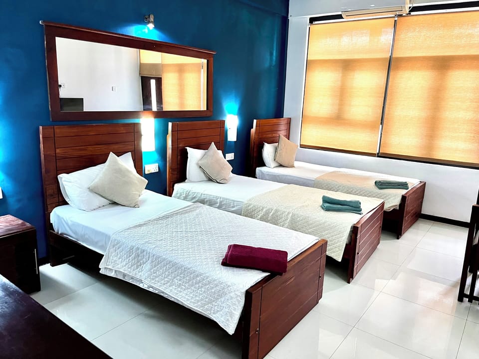 Deluxe Triple Room | Desk, blackout drapes, iron/ironing board, WiFi (free)