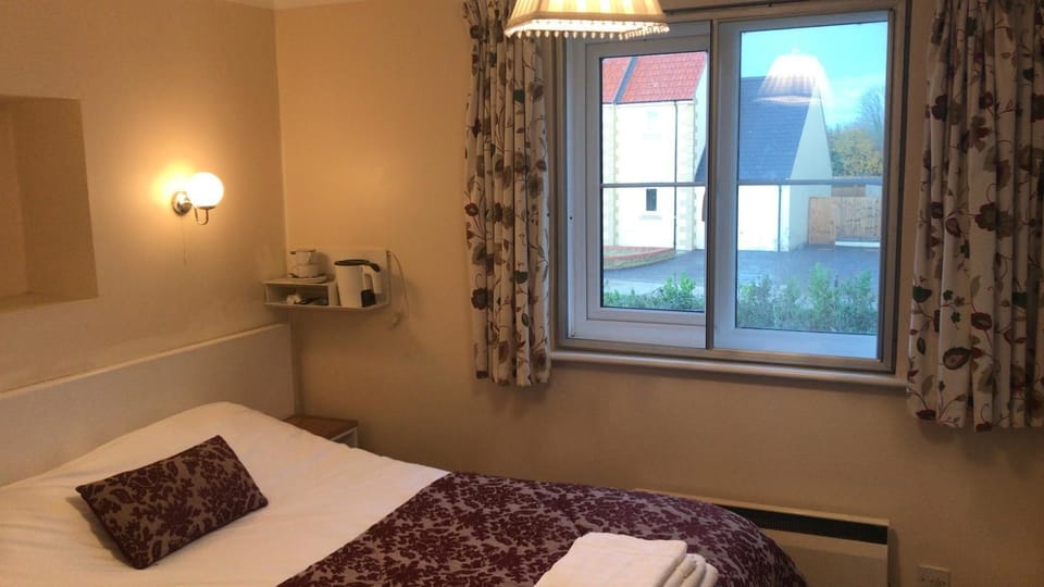 Desk, iron/ironing board, bed sheets