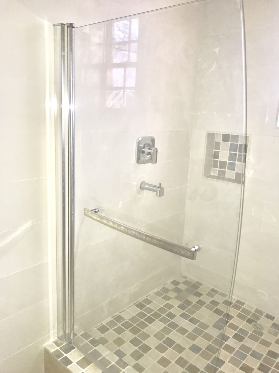 Bathroom with spacious shower and closet space.