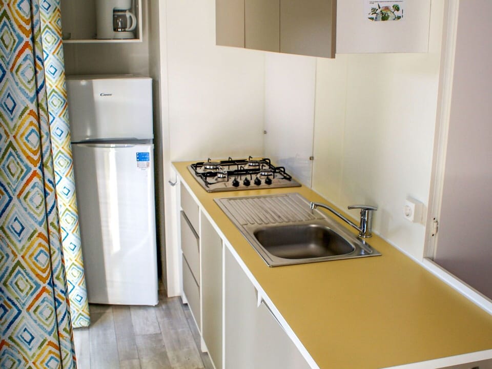 Room, Property, Countertop, Yellow, Kitchen, Floor, Major Appliance, Laundry Room, Furniture, Building