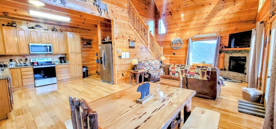 Spacious open concept living area; stone gas fireplace seasonally in operation during winter months