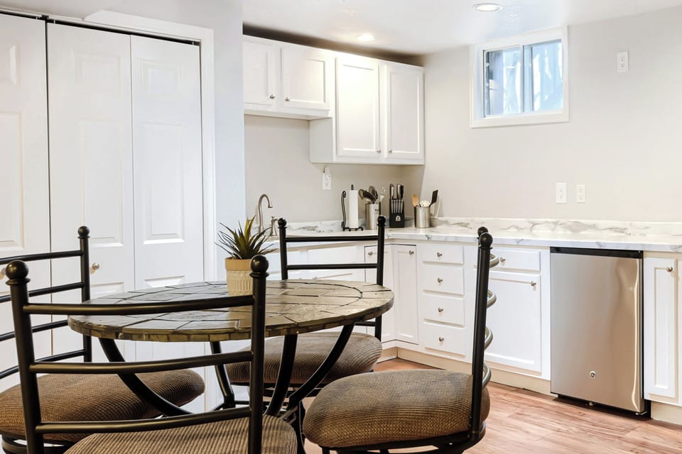Kitchenette with breakfast nook, bar sink, and mini fridge
