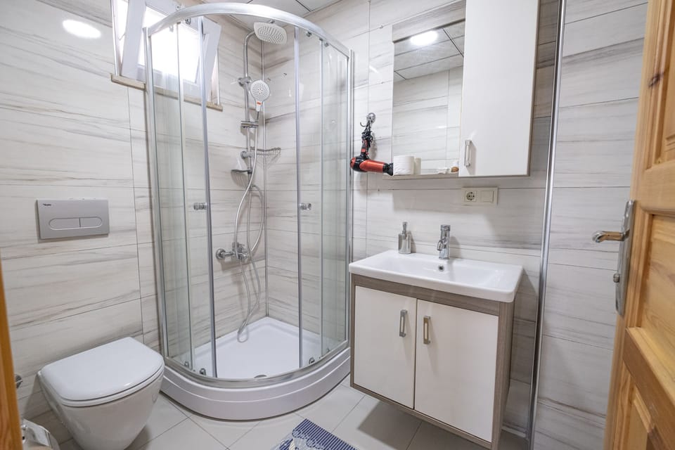 Shower, hair dryer, slippers, towels