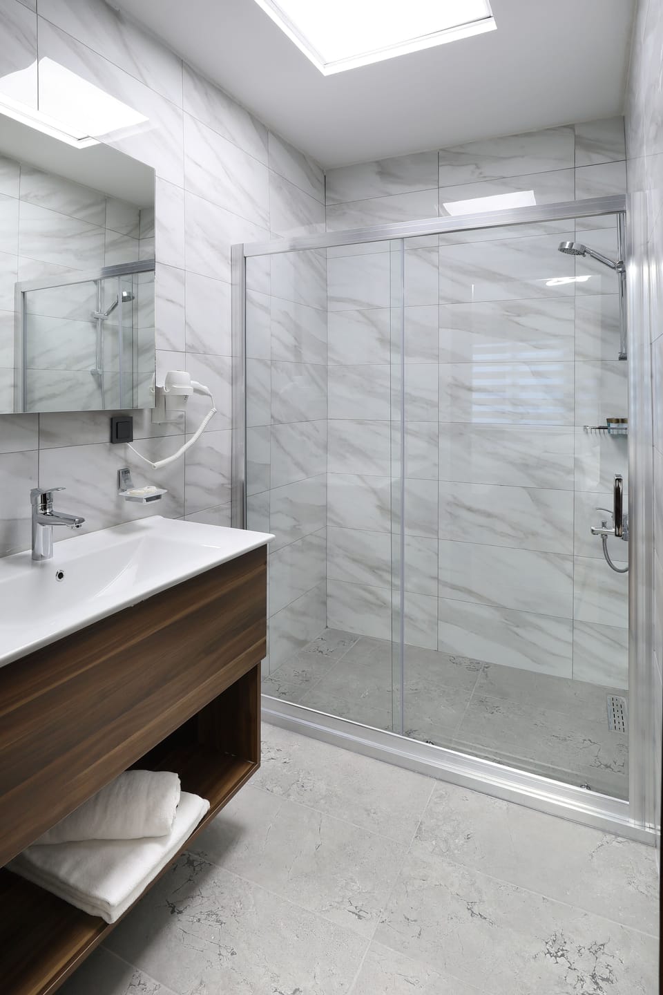 Shower, designer toiletries, hair dryer, slippers