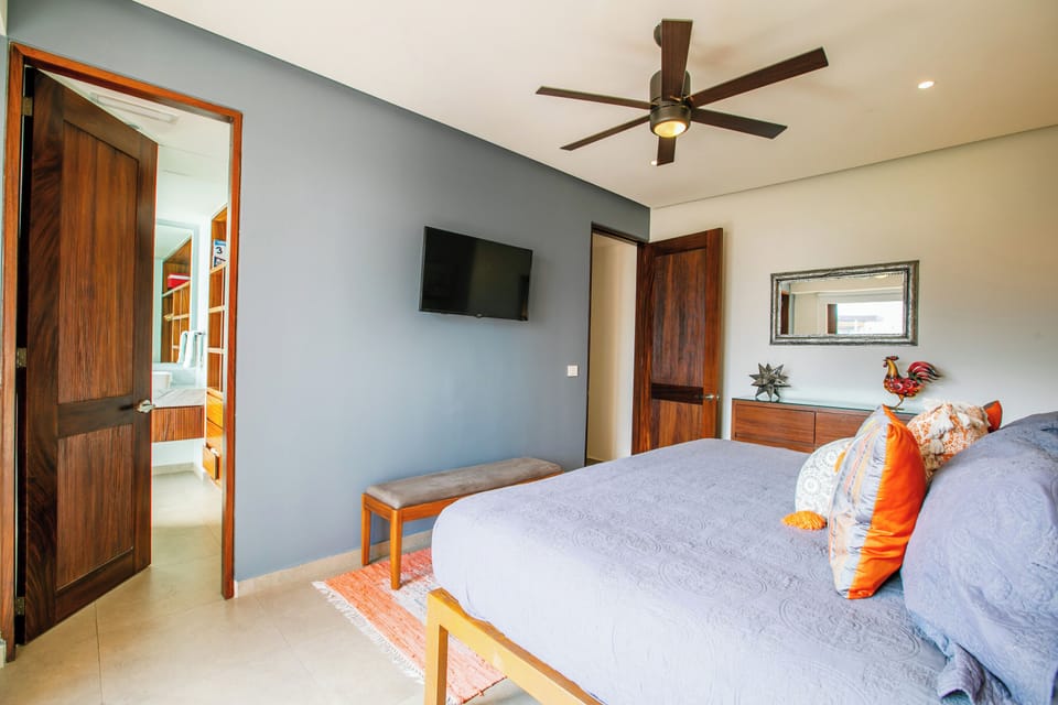 Stylish bedroom with smart TV, ensuite bathroom and balcony