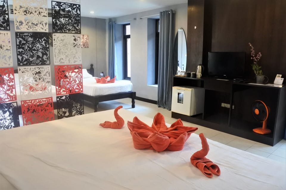 Family Quadruple Room | Minibar, in-room safe, desk, blackout drapes
