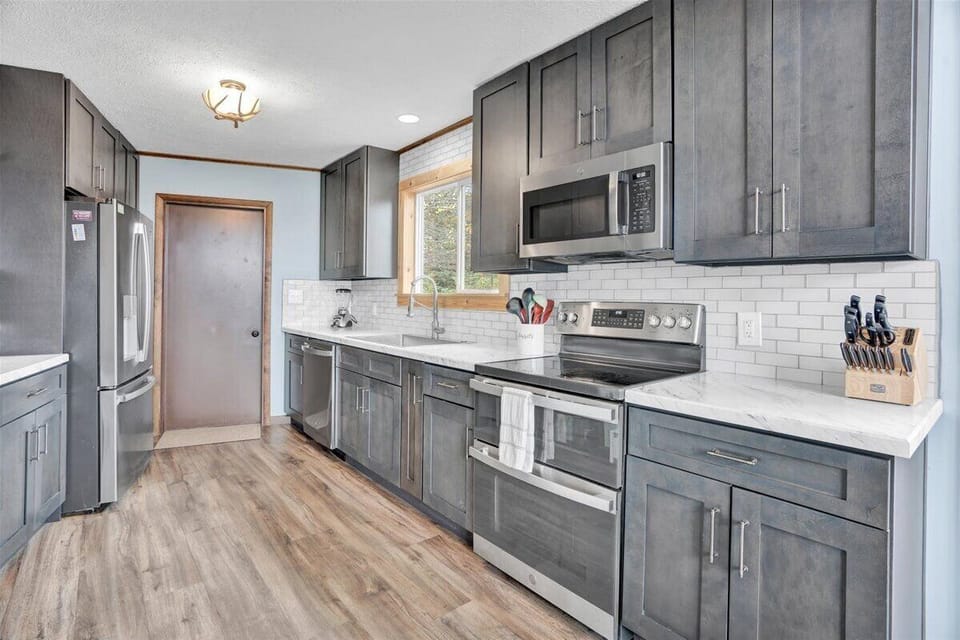 Kitchen with all the essentials - dishes, pots, pans, blender, bakeware & more! 