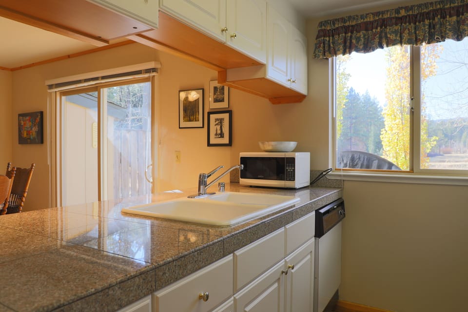 nicely equipped kitchen overlooks the meadow