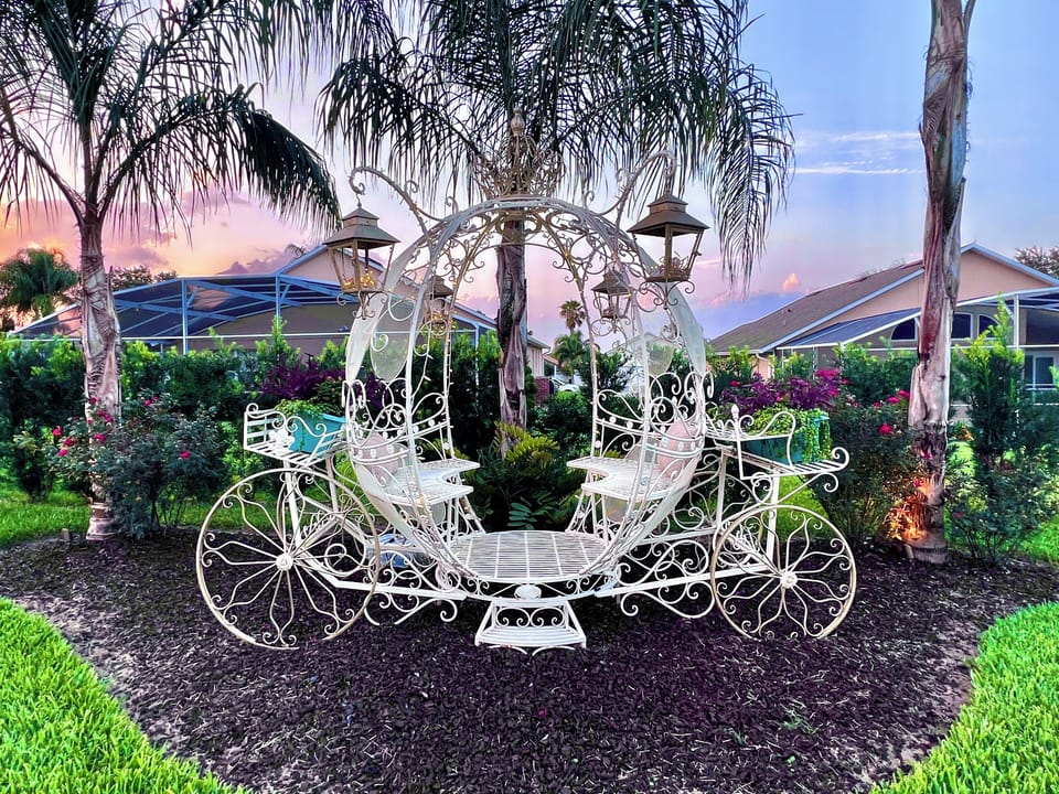 CINDERELLA'S life-sized carriage is in the private, backyard flower gardens!