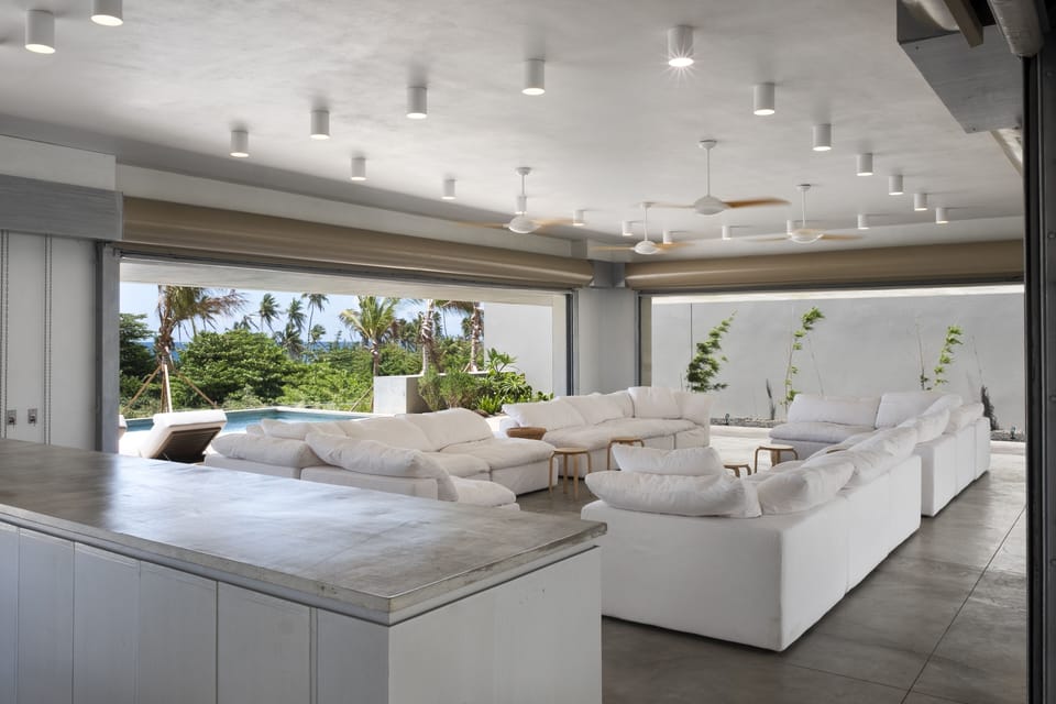 Living room with Caribbean Sea views surrounded by bamboo gardens.