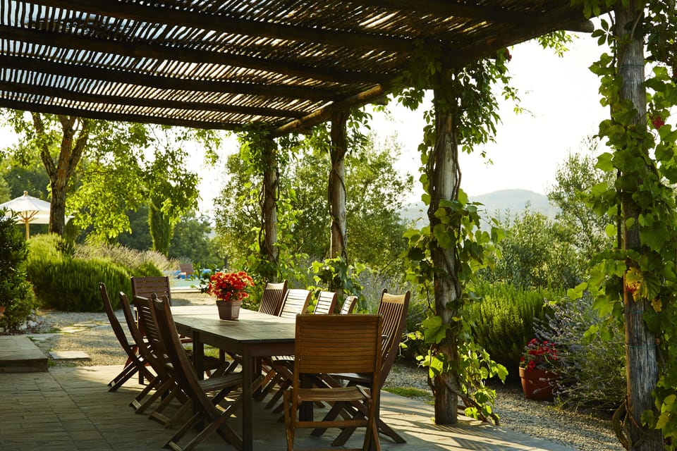 The pergola, with seating for up to 12 people, and view of pool  