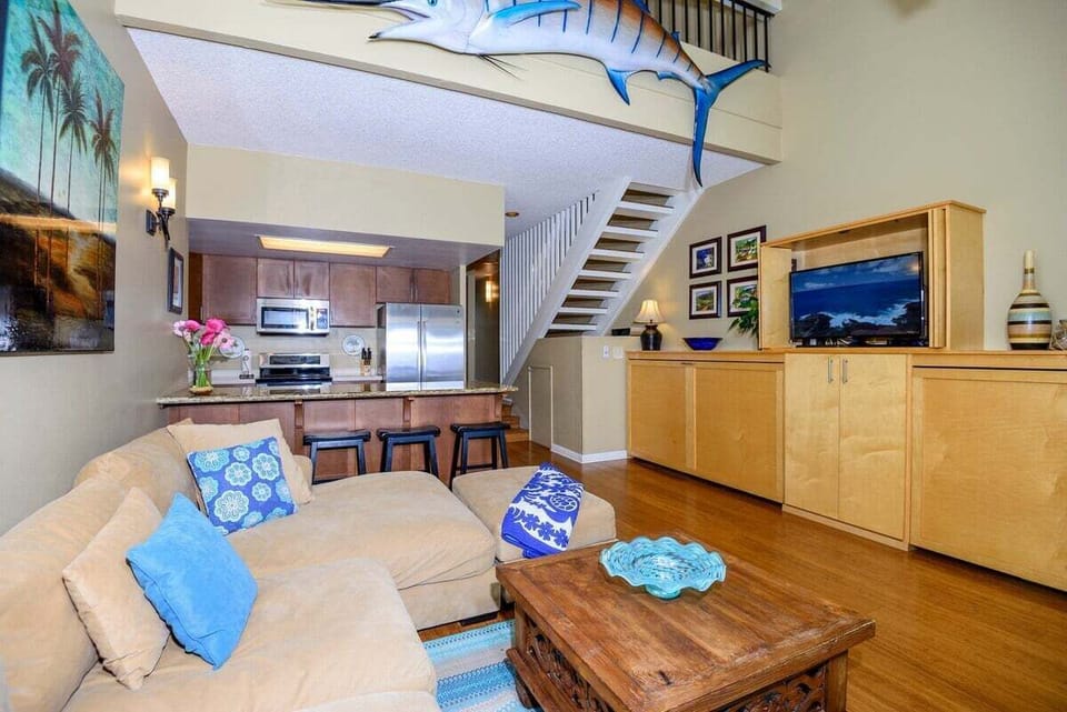 Open living area with kitchen and stylish tropical decoe