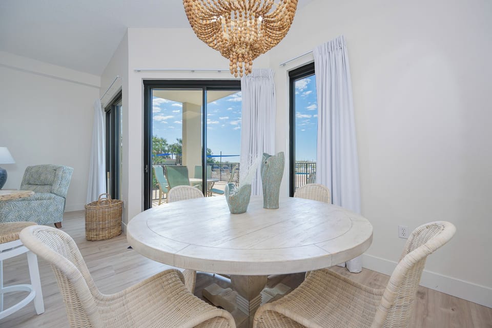 Dine at the round table with a view of the pool, surrounded by natural light from large sliding doors