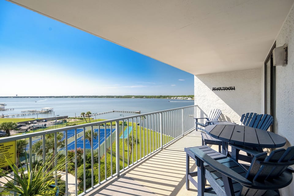 Enjoy tranquil views of the lagoon from the cozy balcony with inviting outdoor seating and space to hang your beach towels