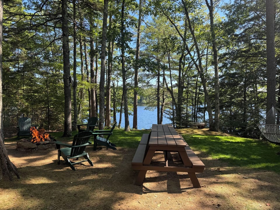 Two picnic tables with view of the lake for outdoor dining.