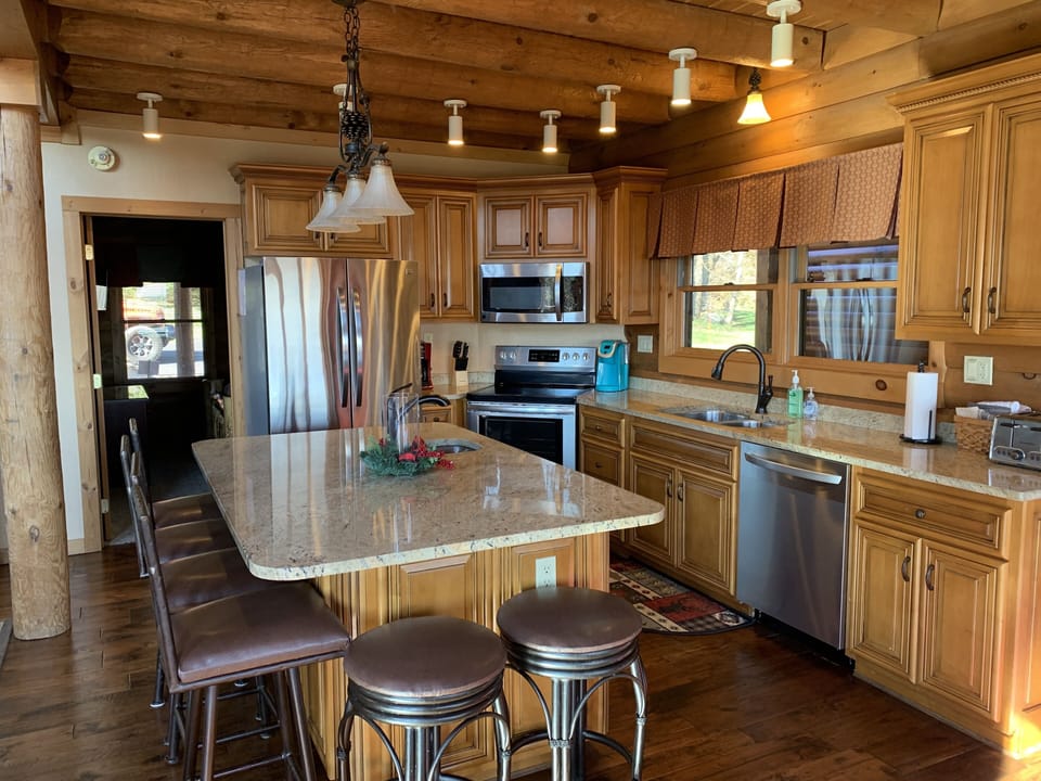 The kitchen is up to date with stainless steel appliances & granite countertops.
