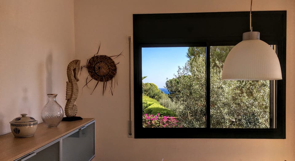The dining room window overlooking the garden and, in the distance, the sea