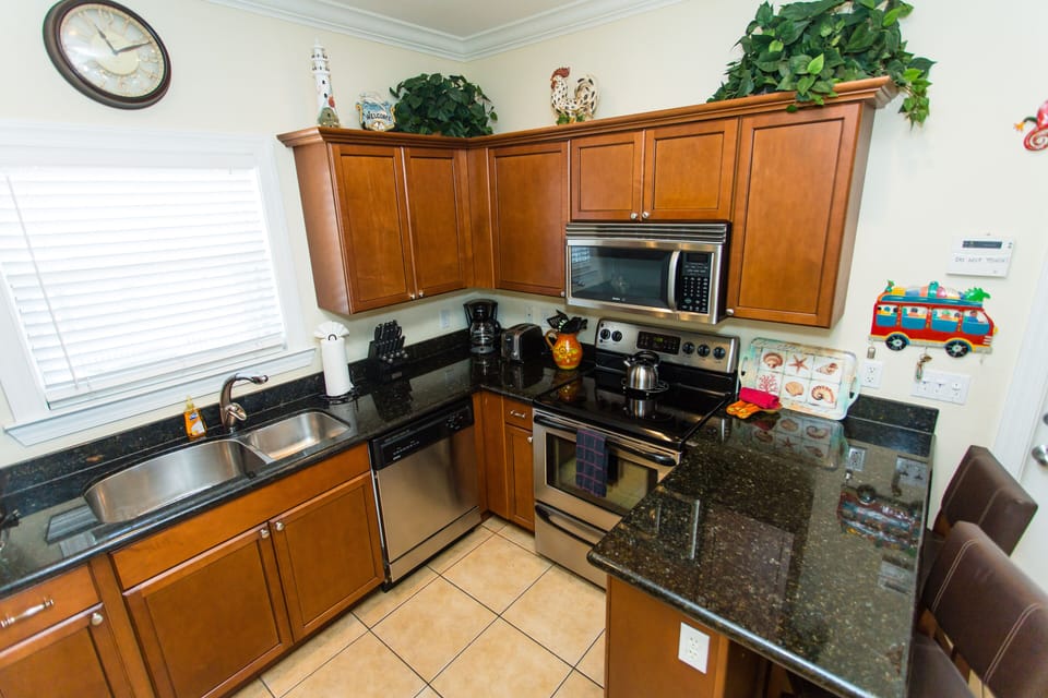 Granite ctops and stainless appliances in a fully stocked kitchen included