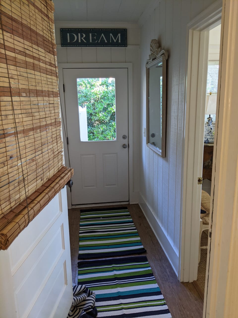 Side entry into laundry area , back primary bwdroom / bath and outdoor shower